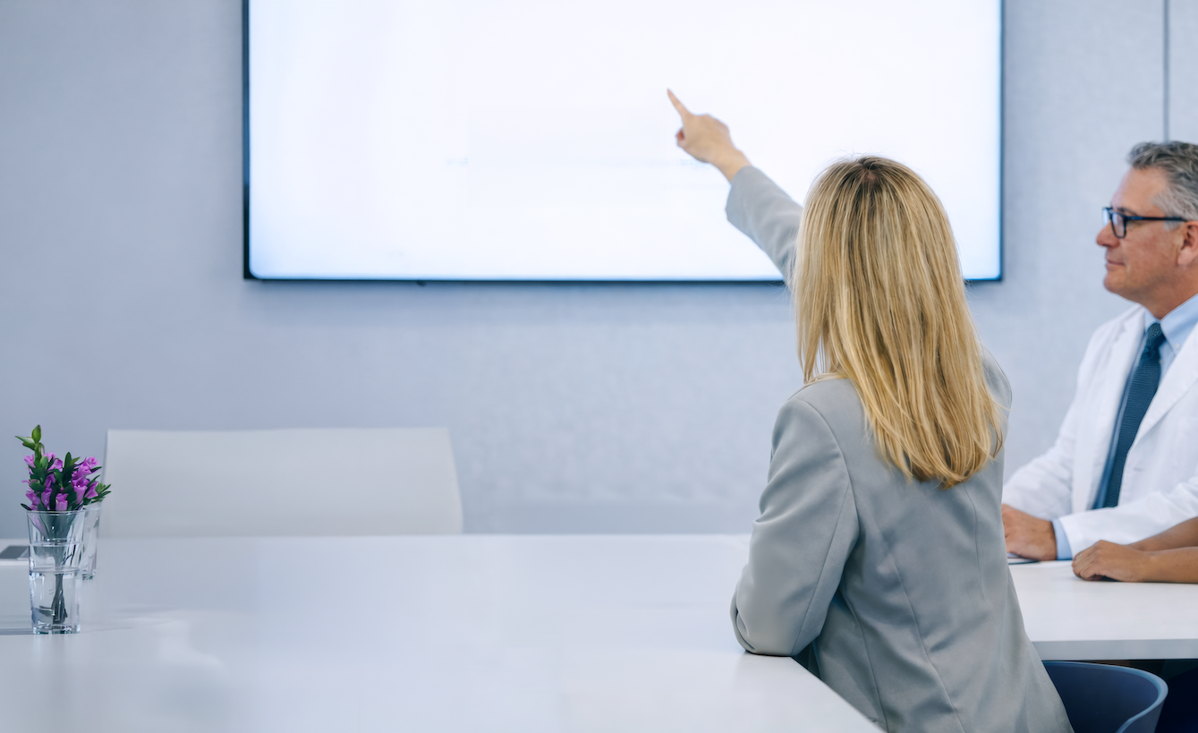Dr. Alexa Lean in a conference room consulting with colleagues